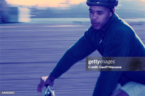 close-up of a man riding a bicycle - schwenk stock-fotos und bilder