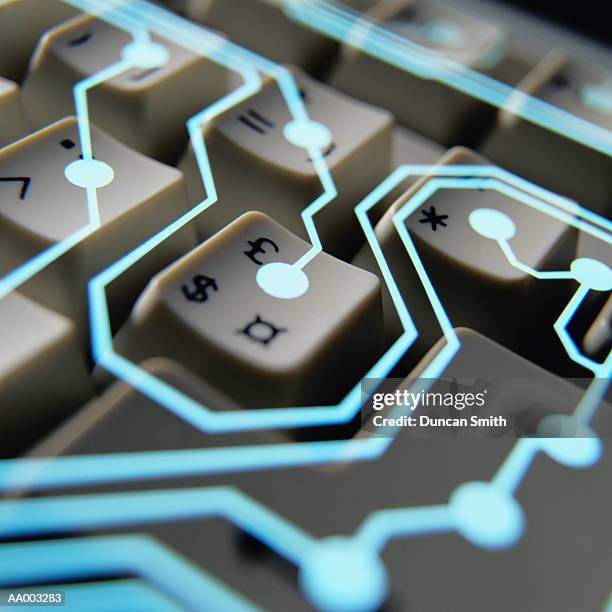 circuitry superimposed on a computer keyboard - dollar sign key stock pictures, royalty-free photos & images