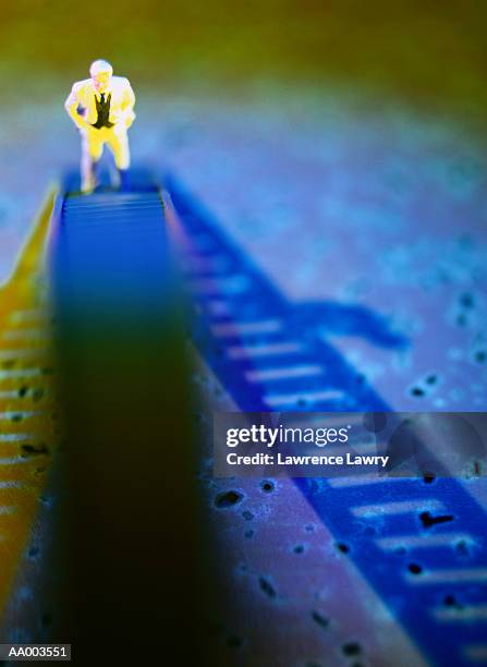 small human figurine climbing a tall ladder - lawrence lader stock pictures, royalty-free photos & images