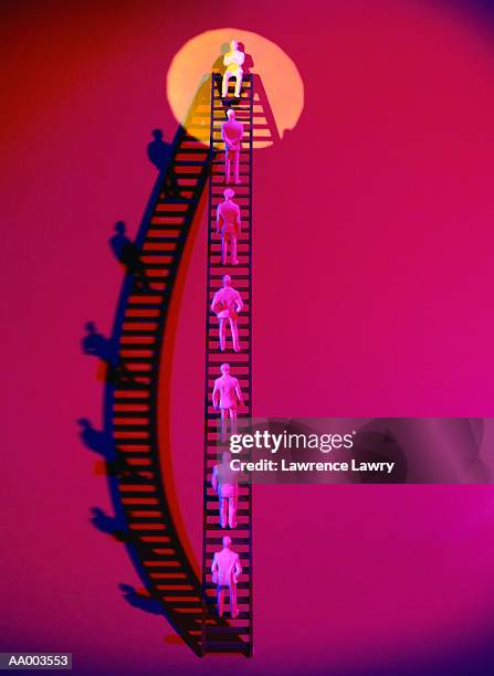 human figurines climbing to the top of a ladder - lawrence lader stock pictures, royalty-free photos & images