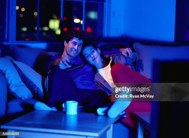 couple on a couch watching television - late night television bildbanksfoton och bilder