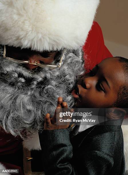 close-up of a boy talking to santa claus - santa close up stock-fotos und bilder