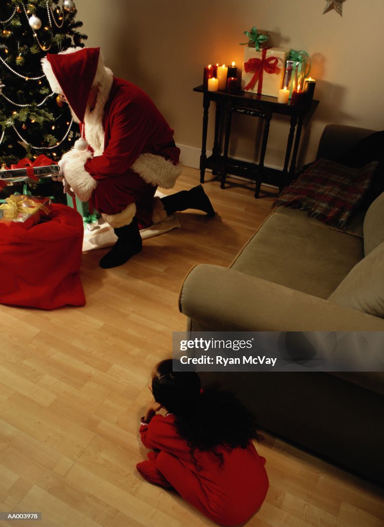 Boy Watching Santa Claus by the Christmas Tree