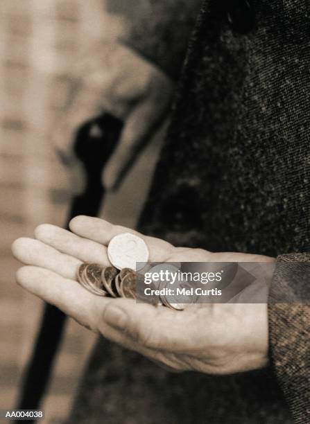 man holding coins in the palm of his hand - coin in palm of hand stock pictures, royalty-free photos & images