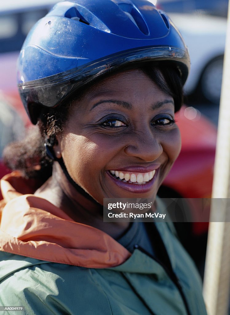 Portrait of a Smiling Woman in a Bicycle Helmet