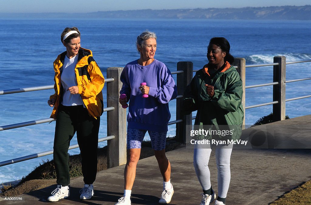 Three Women Walking Beside the Ocean