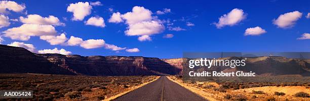 road through the desert in monument valley - the monument stock pictures, royalty-free photos & images