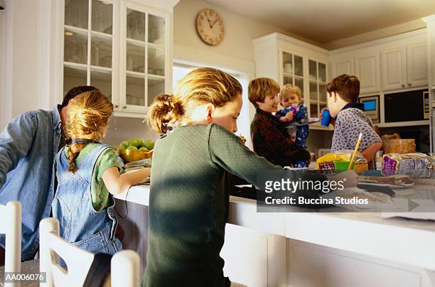 family in the kitchen - familie mit vier kindern stock-fotos und bilder