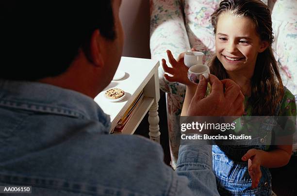 father and daughter toasting at a tea party - tea party fotografías e imágenes de stock
