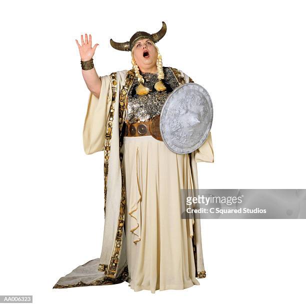 opera singer in a viking helmet - viking helmet stock-fotos und bilder