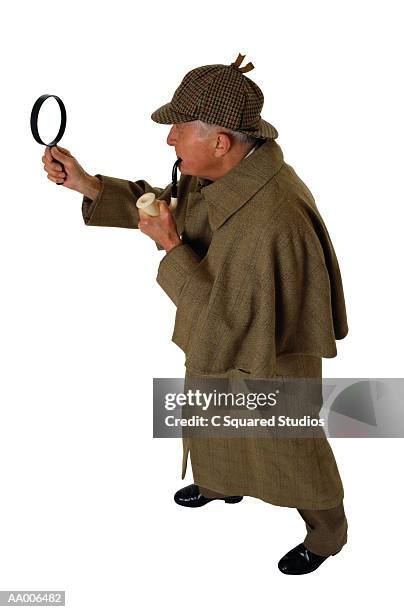 sherlock holmes holding pipe and magnifying glass - deerstalker hat stock pictures, royalty-free photos & images