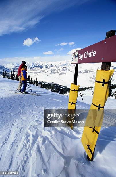 skiers at the top of big chute ski run - chute ski fotografías e imágenes de stock