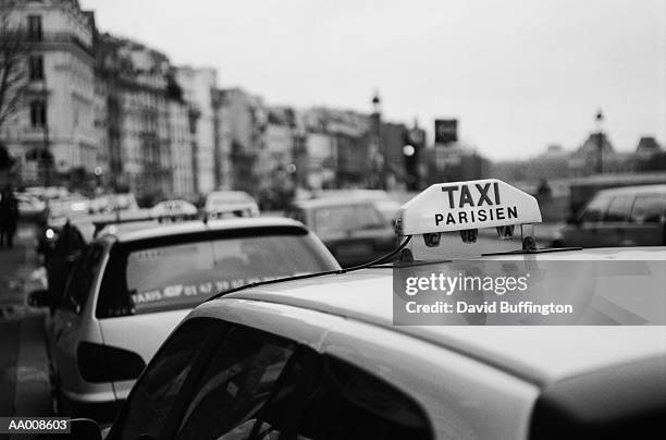 taxis in paris - taxi sign stock pictures, royalty-free photos & images