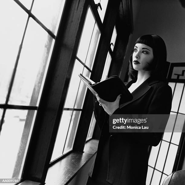 businesswoman looking out a window - monica askew stock pictures, royalty-free photos & images