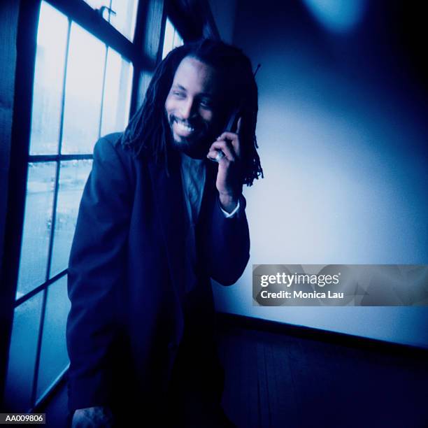 portrait of a businessman on a cellular phone - monica askew stock pictures, royalty-free photos & images