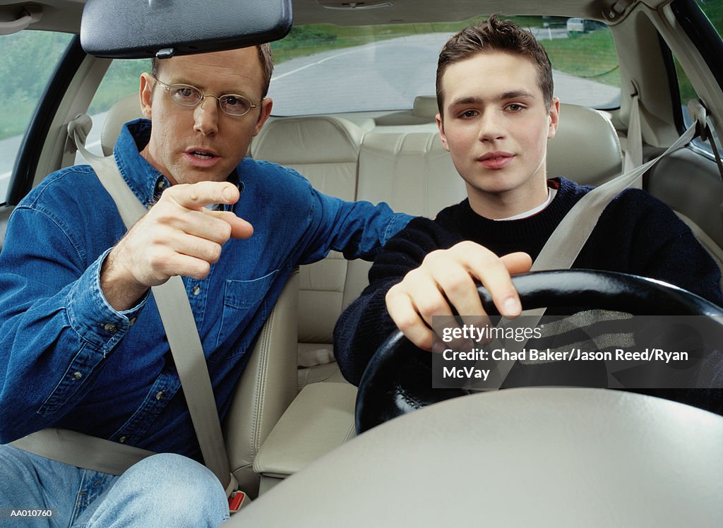 Man Teaching a Boy How to Drive