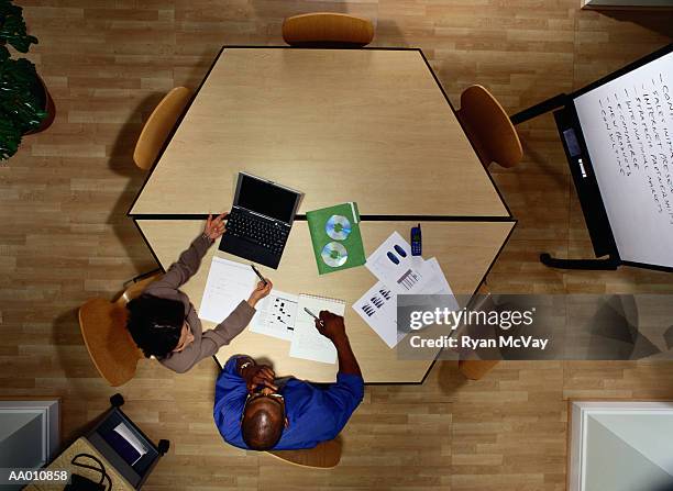 above view of businesspeople working at a table - rom above stock pictures, royalty-free photos & images