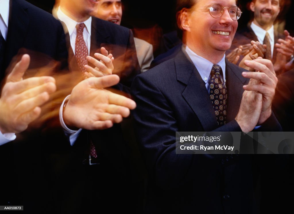 Businessmen clapping (blurred motion)