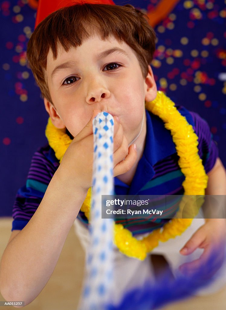 Portrait of a Boy Blowing a Noisemaker