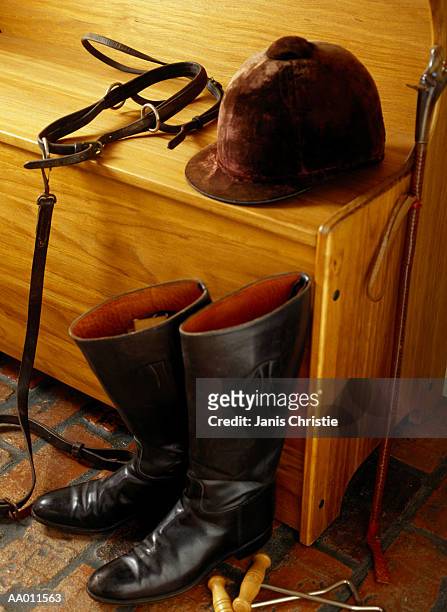 equestrian gear on a bench - equestrian helmet stock-fotos und bilder
