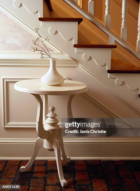 white vase on a table beside stairs - hollister stock pictures, royalty-free photos & images