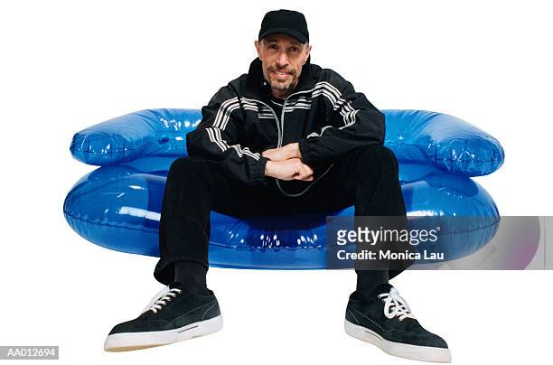 man sitting on an inflatable chair - bubble chair stock pictures, royalty-free photos & images