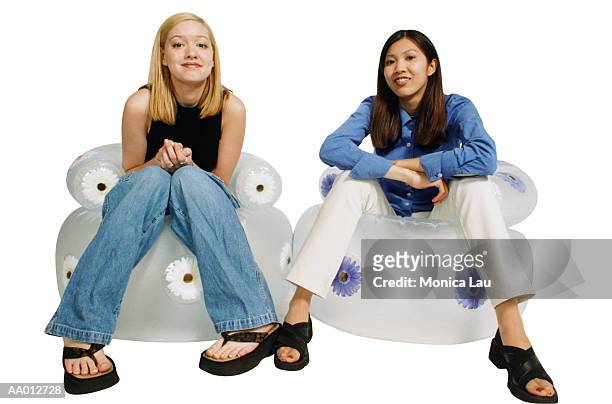two girls sitting on inflatable chairs - bubble chair stock pictures, royalty-free photos & images