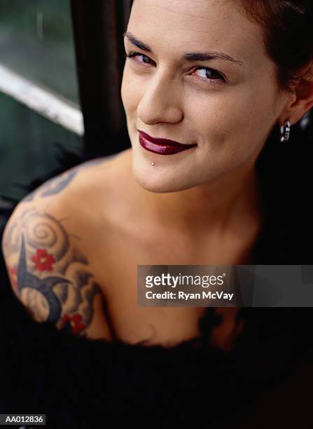 portrait of a woman with tattoos - tattoo shoulder stock-fotos und bilder