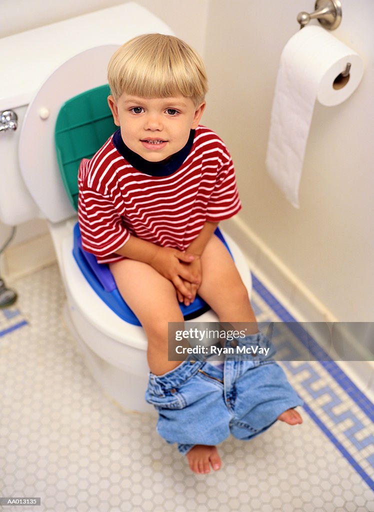Boy Sitting on a Potty Chair