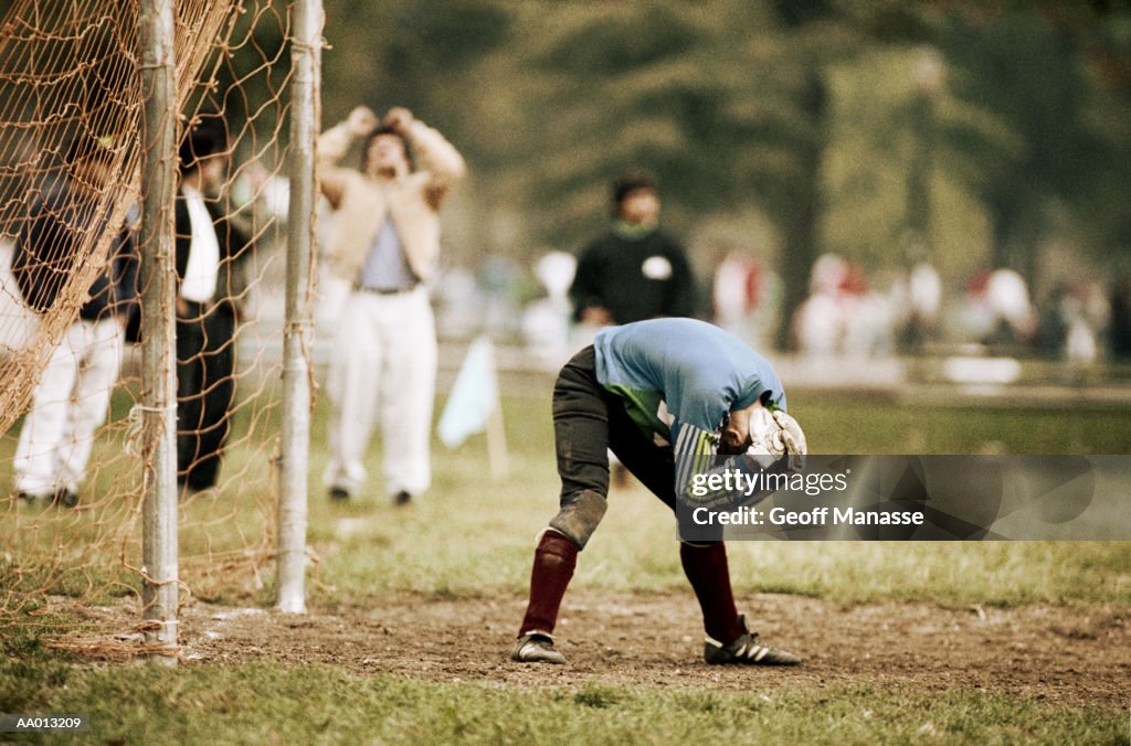 Goalie Bending Over After Missing a Goal
