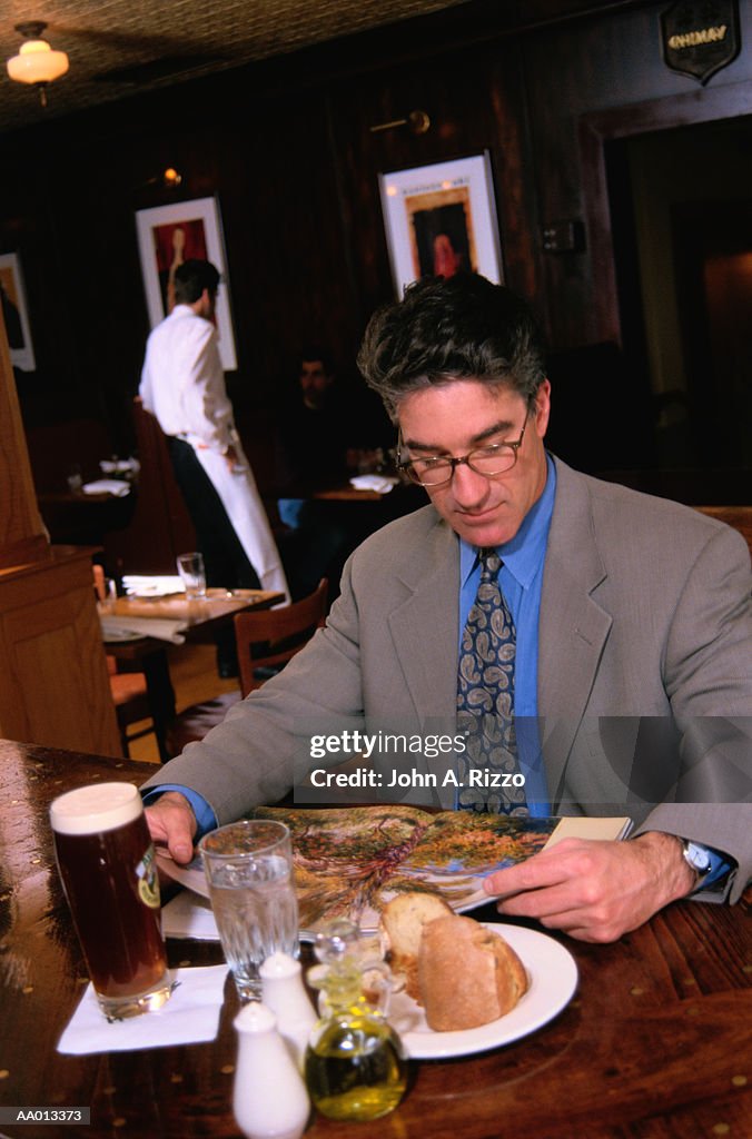 Businessman Reading in a Restaurant