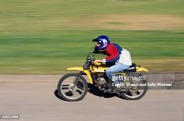 teen boy riding a motorcycle - panorering bildbanksfoton och bilder