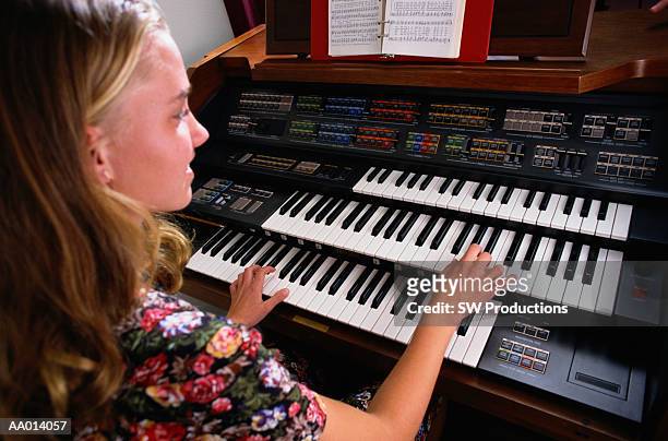 girl playing the organ at church - música religiosa fotografías e imágenes de stock