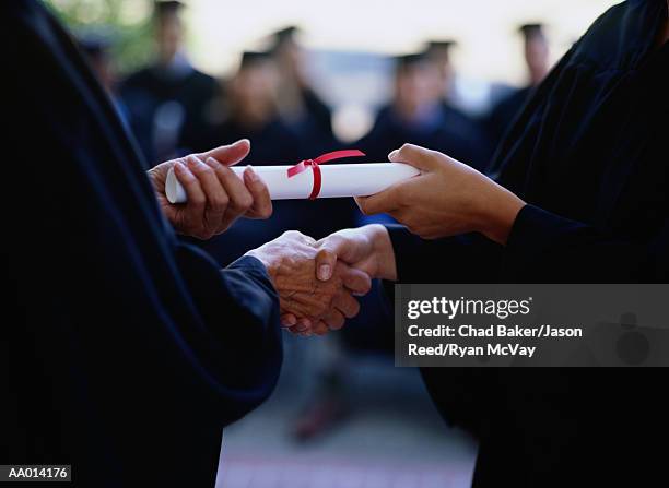 graduate receiving a diploma, close-up of hands - receiving diploma stock pictures, royalty-free photos & images