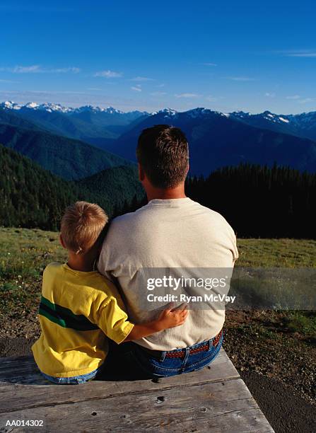 father and son looking at the olympic mountains - hurricane ridge stock pictures, royalty-free photos & images