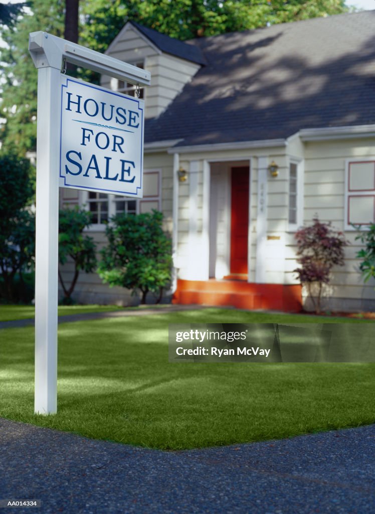 For Sale Sign in Front of a House