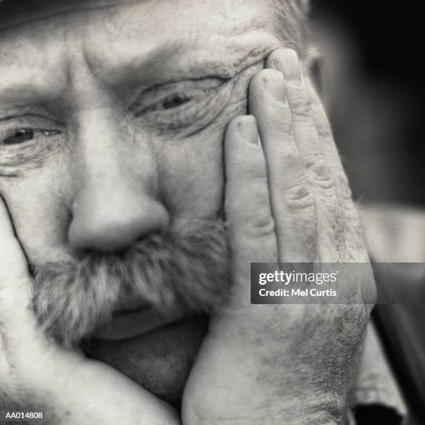 worried man holding his face in his hands - handlebar moustache stock pictures, royalty-free photos & images