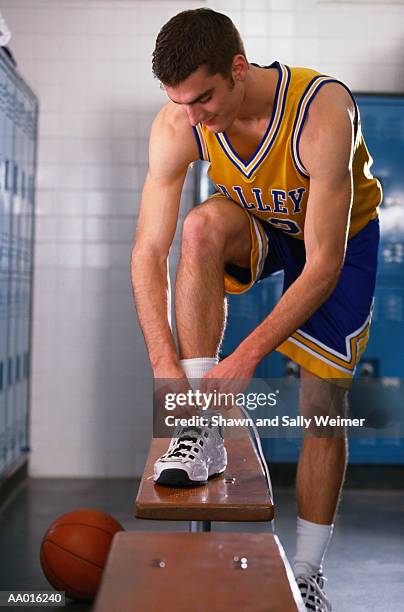 tying shoes - young boys changing in locker room imagens e fotografias de stock