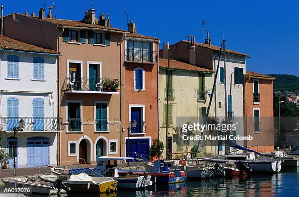 motorboats and houses lining a marina - martigues stock pictures, royalty-free photos & images