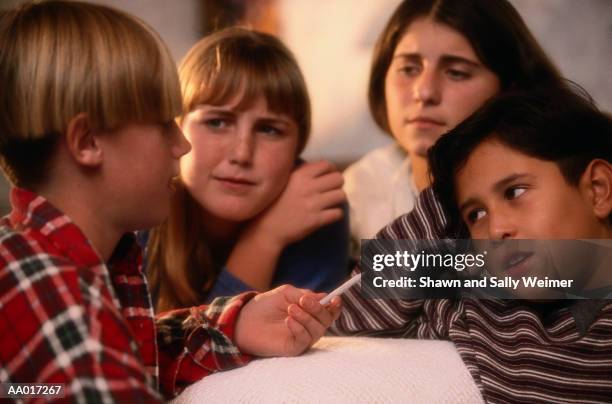 child offering marijuana to other children - druck durch gleichaltrige stock-fotos und bilder