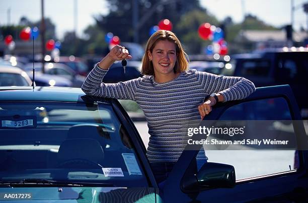 girl with car keys at a car dealership - car door stock pictures, royalty-free photos & images
