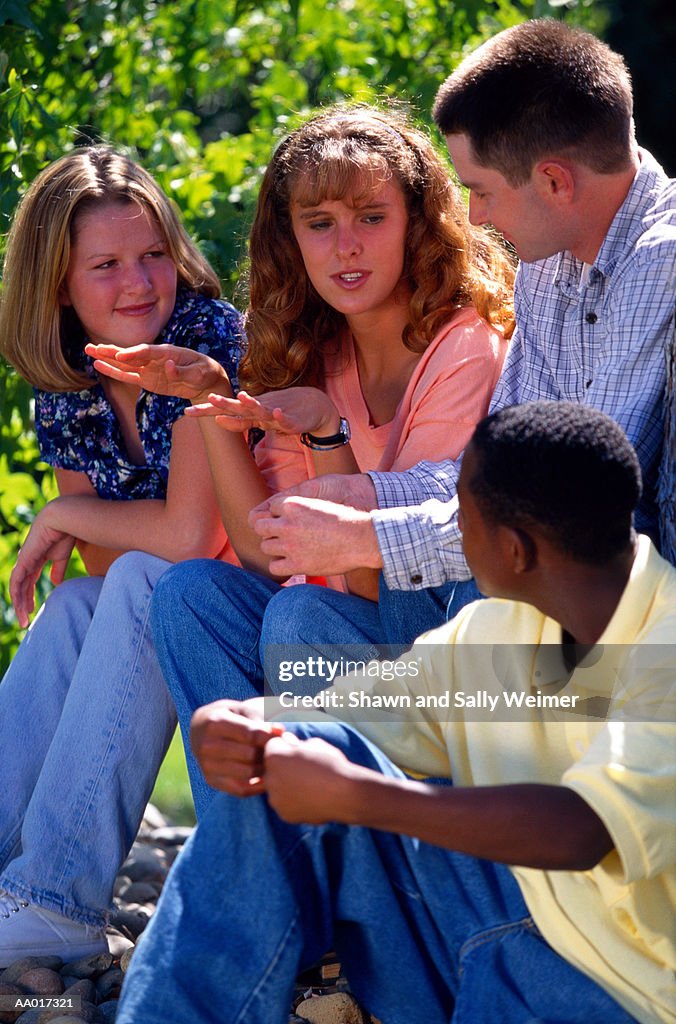 Four Teens Talking Outside