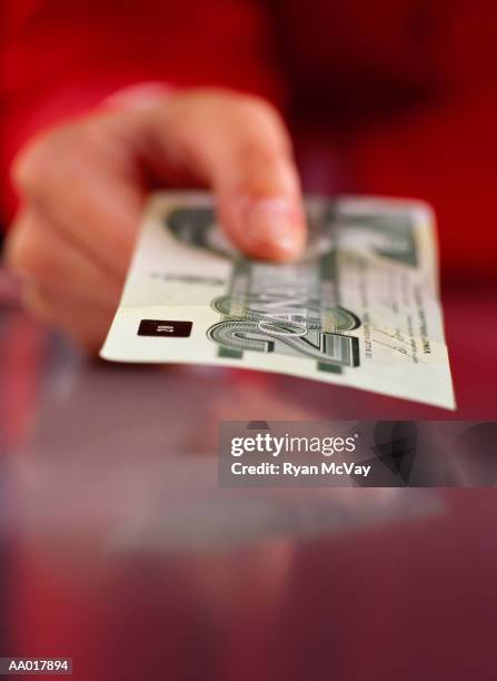 hand holding a canadian twenty dollar bill - twenty canadian dollar note stock pictures, royalty-free photos & images