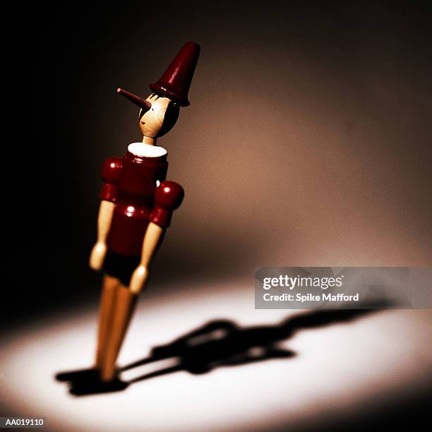 wooden pinocchio figurine - long nose stock pictures, royalty-free photos & images