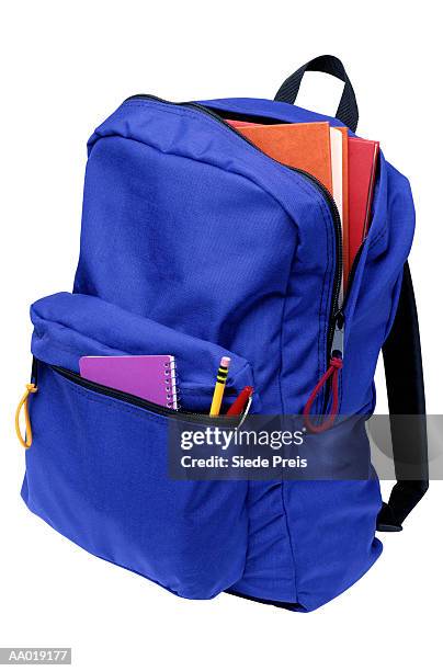 backpack full of school supplies - rugzak stockfoto's en -beelden