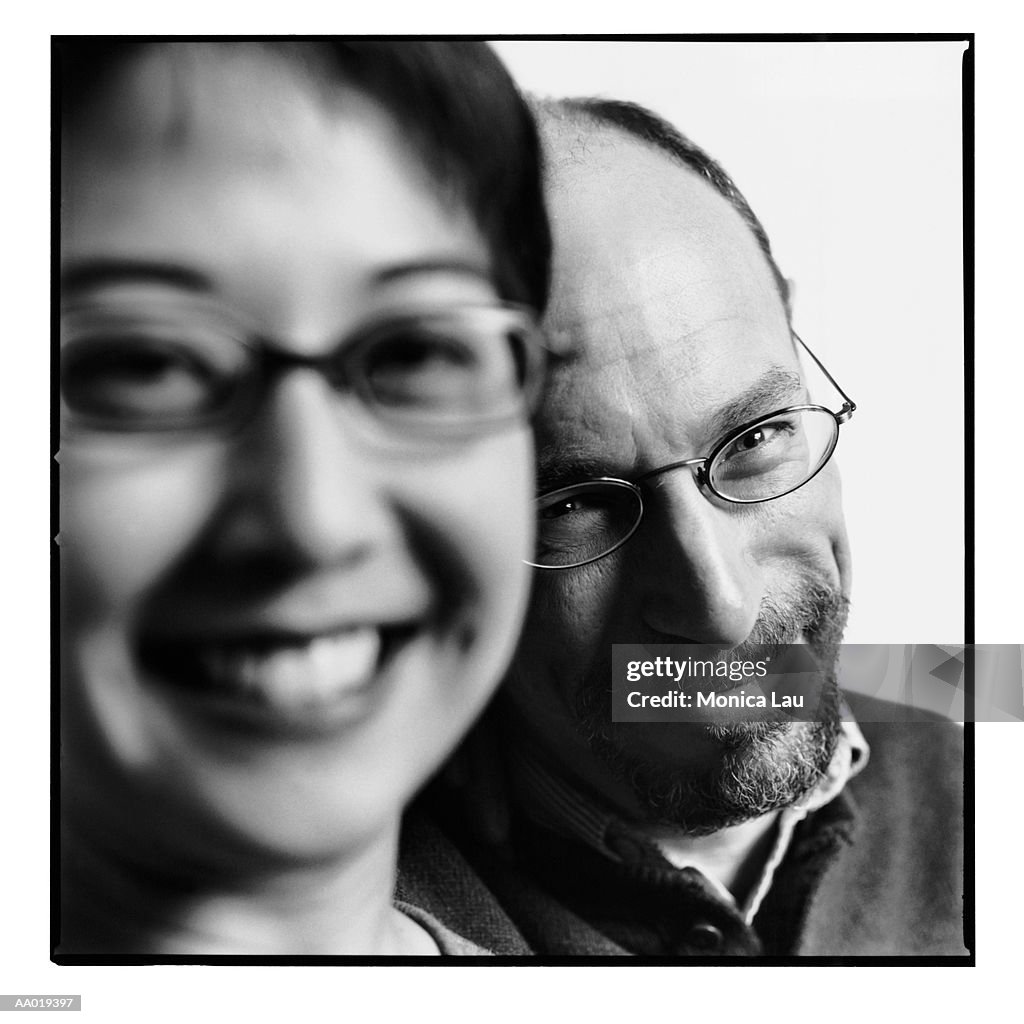 Mature couple smiling, close-up, portrait (focus on man, B&W)