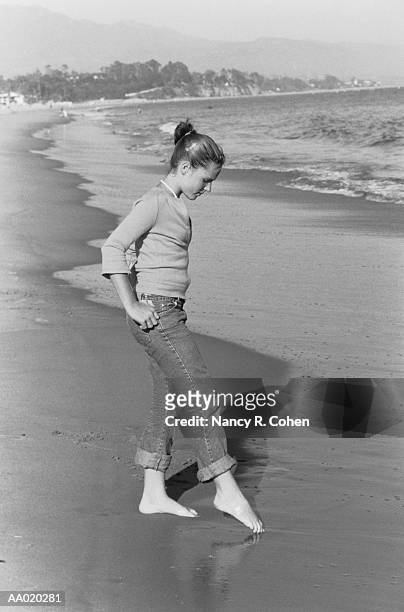 teen girl feeling water temperature at the beach - teen girls toes stock pictures, royalty-free photos & images