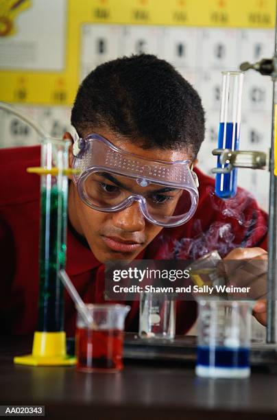 boy performing a scientific experiment - measuring beaker stock pictures, royalty-free photos & images