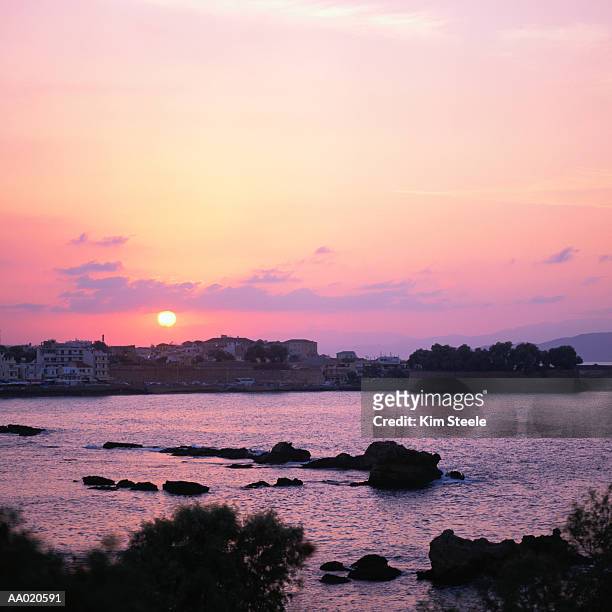 sunset over the sea of crete and chania harbor - sea of crete stock pictures, royalty-free photos & images
