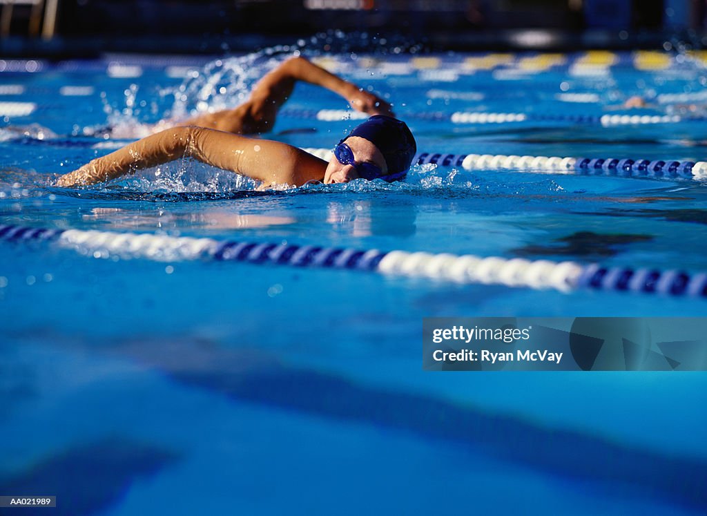 Swimmer Racing in a Swimming Pool